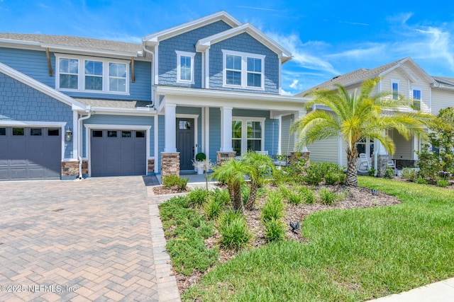 843 Windley Dr, Saint Augustine, FL 32092 - craftsman-style house with covered porch, decorative driveway, and a garage