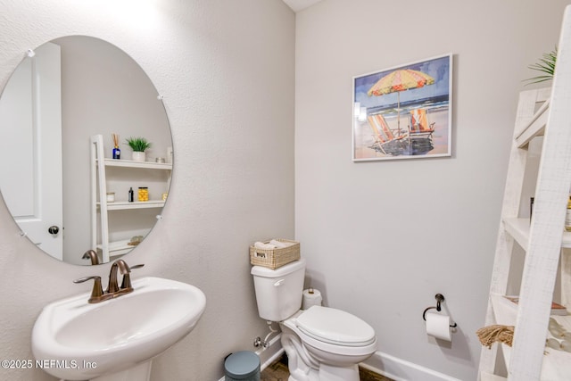 843 Windley Dr, Saint Augustine, FL 32092 - half bath featuring a sink, toilet, and baseboards