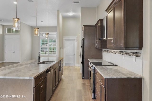 11 Woodstone Ln, Palm Coast, FL 32164 - kitchen with a sink, appliances with stainless steel finishes, light wood-style floors, and healthy amount of natural light
