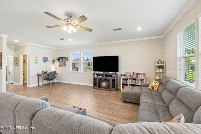 70 Creekmore Dr, Saint Augustine, FL 32092 - living room featuring light wood-style flooring, crown molding, ceiling fan, recessed lighting, and a lit fireplace