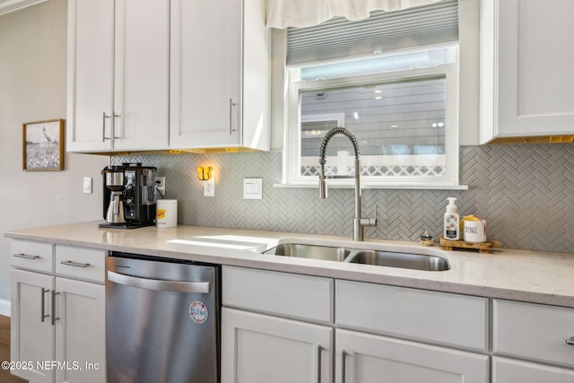 70 Creekmore Dr, Saint Augustine, FL 32092 - kitchen featuring stainless steel dishwasher, decorative backsplash, white cabinets, and light stone countertops
