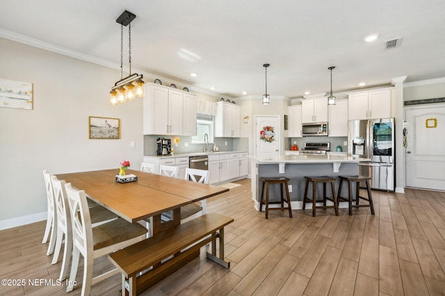 70 Creekmore Dr, Saint Augustine, FL 32092 - dining space featuring ornamental molding, light wood-style floors, and recessed lighting