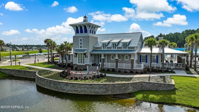 70 Creekmore Dr, Saint Augustine, FL 32092 - rear view of house featuring a water view, a metal roof, a lawn, covered porch, and a standing seam roof