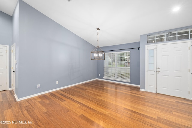 2007 Hollington Dr, Jacksonville, FL 32246 - entryway with a chandelier, vaulted ceiling, wood finished floors, and baseboards