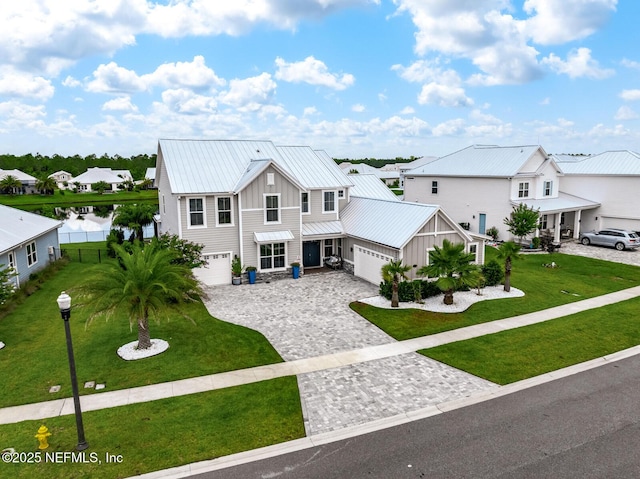 83 Tortola Way, Saint Johns, FL 32259 - view of front of house with board and batten siding, decorative driveway, a residential view, a metal roof, and a standing seam roof