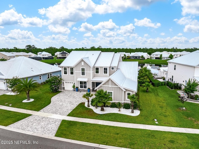 83 Tortola Way, Saint Johns, FL 32259 - view of front of property featuring board and batten siding, a residential view, decorative driveway, a metal roof, and an attached garage