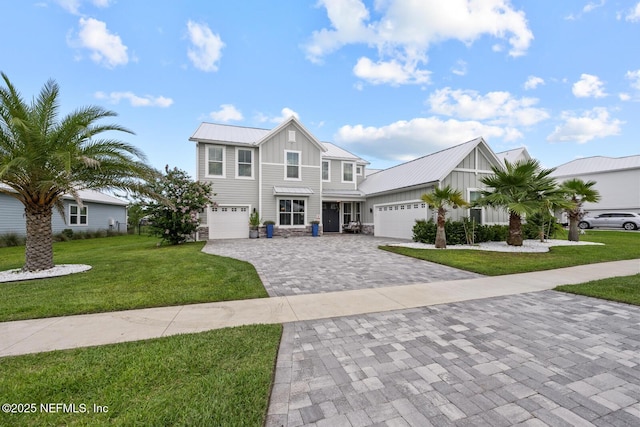83 Tortola Way, Saint Johns, FL 32259 - view of front of property featuring board and batten siding, decorative driveway, a front lawn, a metal roof, and a standing seam roof