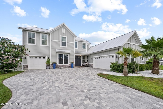 83 Tortola Way, Saint Johns, FL 32259 - view of front of house featuring board and batten siding, decorative driveway, a metal roof, stone siding, and a standing seam roof