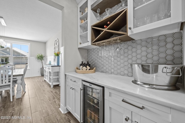 83 Tortola Way, Saint Johns, FL 32259 - indoor dry bar with wine cooler, wood finished floors, and decorative backsplash