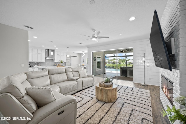 83 Tortola Way, Saint Johns, FL 32259 - living area with a ceiling fan, a fireplace, light wood-style floors, and recessed lighting