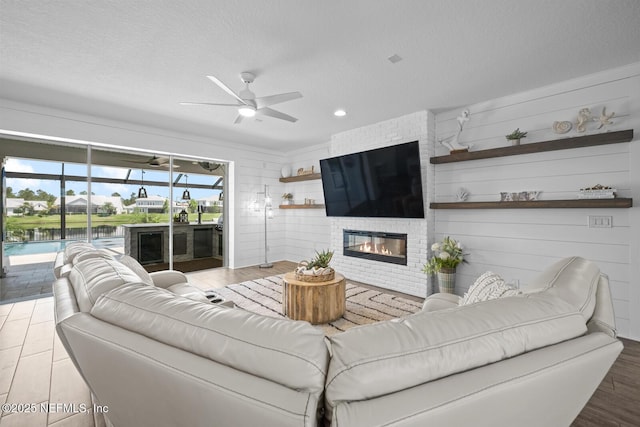 83 Tortola Way, Saint Johns, FL 32259 - living area featuring a ceiling fan, a large fireplace, wood finished floors, a textured ceiling, and recessed lighting