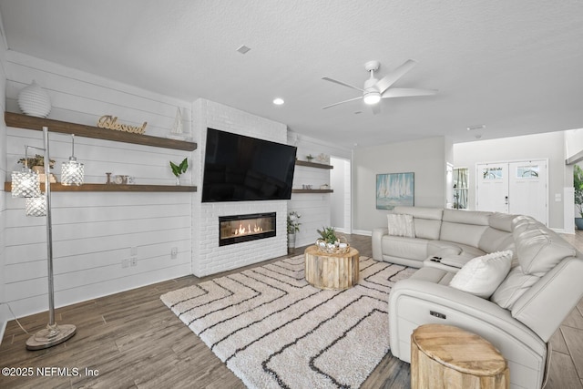 83 Tortola Way, Saint Johns, FL 32259 - living area with ceiling fan, a fireplace, wood finished floors, and a textured ceiling