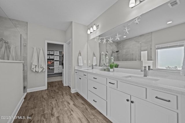 83 Tortola Way, Saint Johns, FL 32259 - full bath featuring double vanity, a stall shower, a walk in closet, and wood finished floors