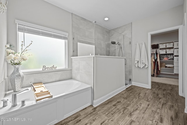83 Tortola Way, Saint Johns, FL 32259 - full bathroom featuring a stall shower, a spacious closet, a garden tub, and wood finished floors