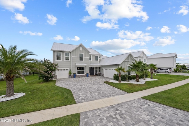 83 Tortola Way, Saint Johns, FL 32259 - view of front of property with board and batten siding, decorative driveway, a front yard, and a metal roof