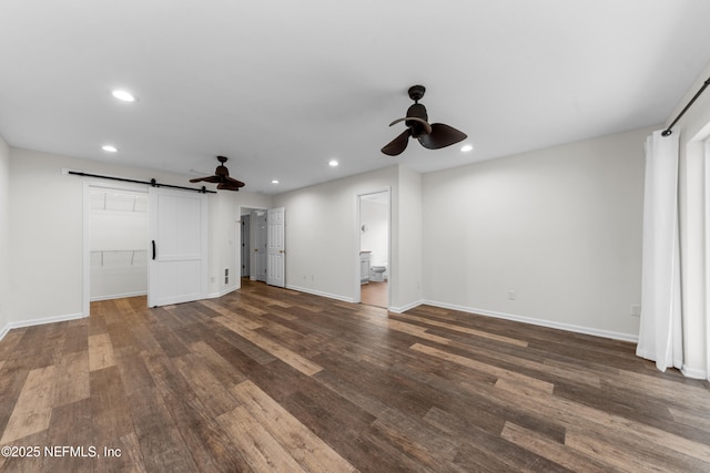 1101 Chokee Pl, Saint Augustine, FL 32092 - unfurnished living room featuring ceiling fan, a barn door, recessed lighting, dark wood finished floors, and baseboards
