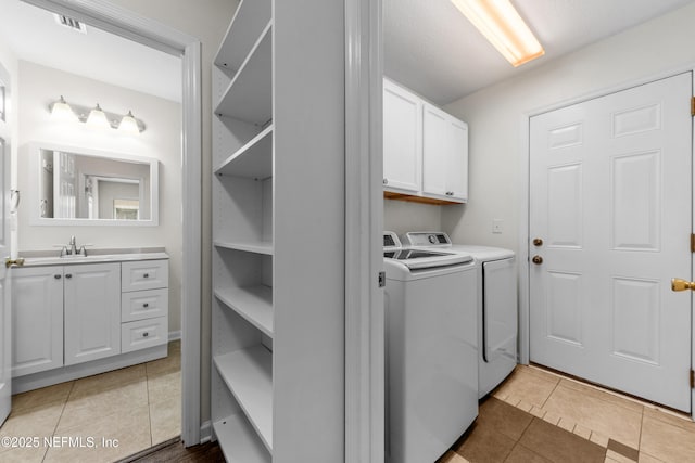1101 Chokee Pl, Saint Augustine, FL 32092 - laundry area featuring washing machine and dryer, cabinet space, and light tile patterned floors