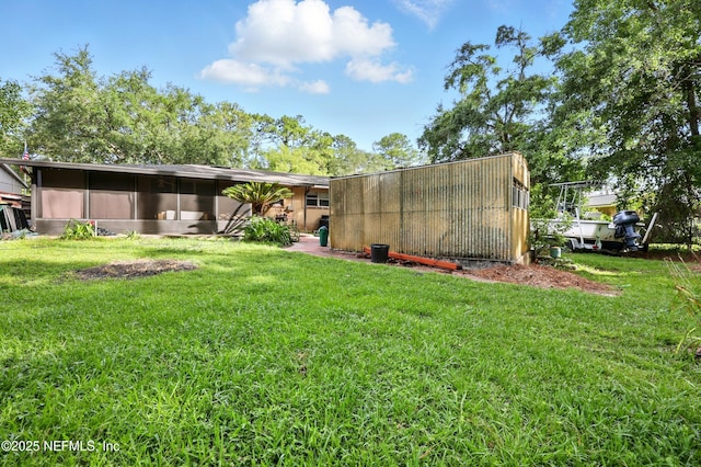 665 Grove Park Blvd, Jacksonville, FL 32216 - rear view of house with a lawn and a sunroom
