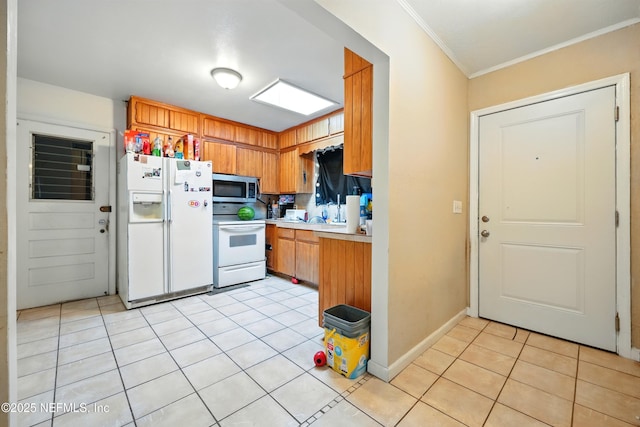 665 Grove Park Blvd, Jacksonville, FL 32216 - kitchen featuring white appliances, crown molding, light tile patterned floors, light countertops, and brown cabinets