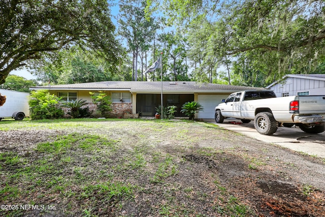 665 Grove Park Blvd, Jacksonville, FL 32216 - view of front of home with an attached garage, concrete driveway, and brick siding