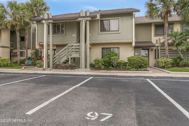 97 Village Las Palmas Cir, Saint Augustine, FL 32080 - view of building exterior featuring stairs and uncovered parking