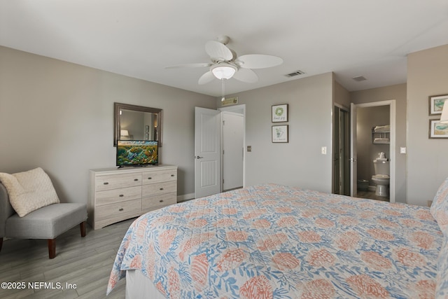 97 Village Las Palmas Cir, Saint Augustine, FL 32080 - bedroom with light wood-style flooring, a ceiling fan, and ensuite bathroom