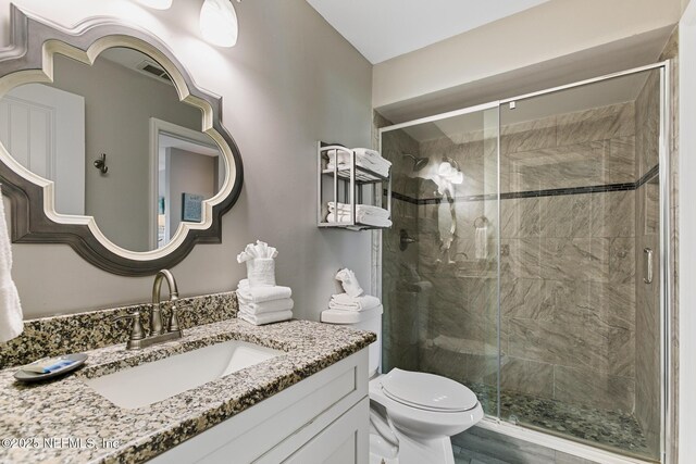 97 Village Las Palmas Cir, Saint Augustine, FL 32080 - bathroom with vanity, toilet, and a stall shower
