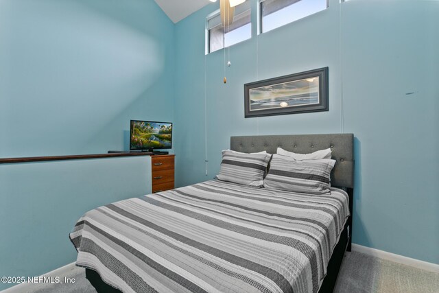 97 Village Las Palmas Cir, Saint Augustine, FL 32080 - carpeted bedroom with lofted ceiling and baseboards