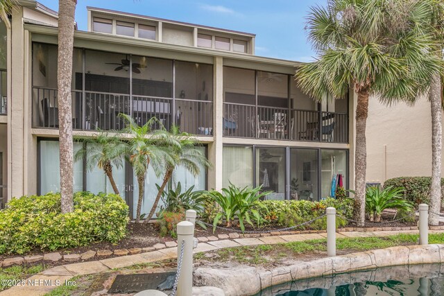 97 Village Las Palmas Cir, Saint Augustine, FL 32080 - rear view of property with stucco siding, a ceiling fan, and a sunroom