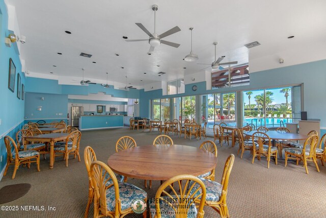 97 Village Las Palmas Cir, Saint Augustine, FL 32080 - dining area featuring carpet floors, ceiling fan, and a high ceiling