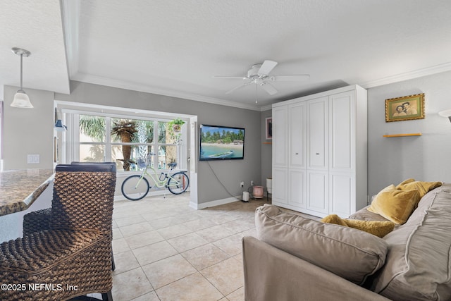 108 Laguna Villas Blvd Unit D22, Jacksonville Beach, FL 32250 - living area with a ceiling fan, light tile patterned flooring, baseboards, crown molding, and a textured ceiling