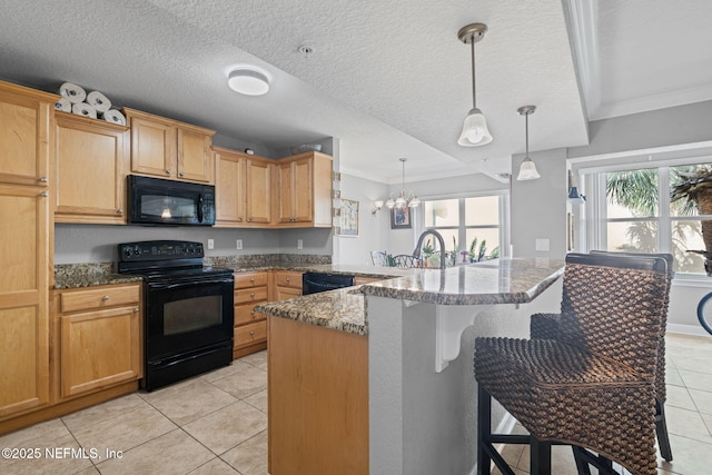 108 Laguna Villas Blvd Unit D22, Jacksonville Beach, FL 32250 - kitchen with black appliances, light tile patterned flooring, crown molding, a breakfast bar area, and a peninsula