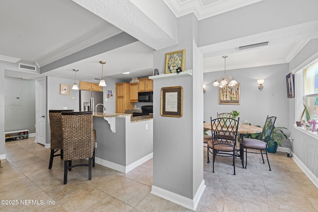 108 Laguna Villas Blvd Unit D22, Jacksonville Beach, FL 32250 - kitchen with black appliances, crown molding, light brown cabinetry, a breakfast bar, and light stone countertops