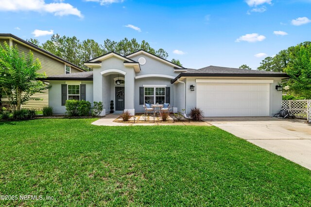 81014 Lockhaven Dr, Yulee, FL 32097 - single story home featuring stucco siding, driveway, an attached garage, and a front yard