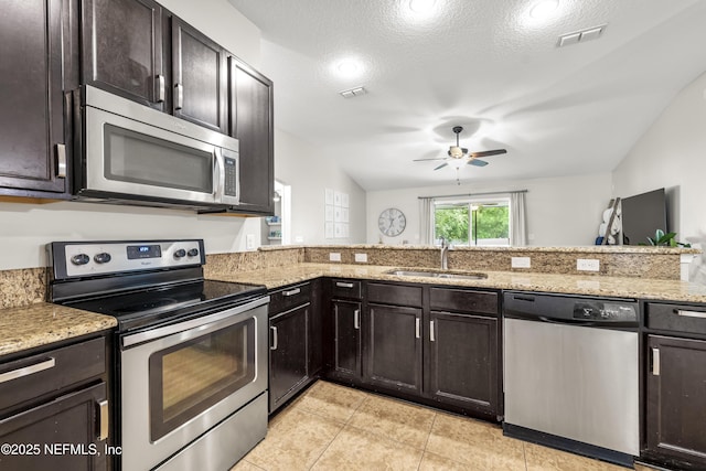 81014 Lockhaven Dr, Yulee, FL 32097 - kitchen with stainless steel appliances, a sink, ceiling fan, light stone countertops, and light tile patterned floors