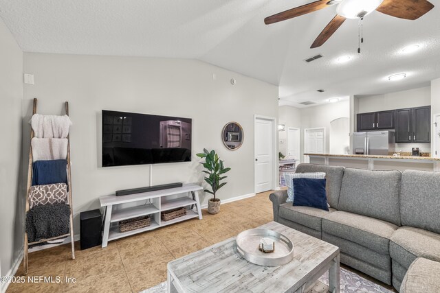 81014 Lockhaven Dr, Yulee, FL 32097 - living area featuring a ceiling fan, light tile patterned flooring, vaulted ceiling, and baseboards