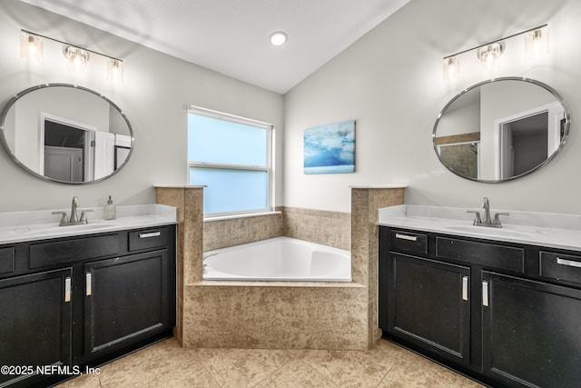 81014 Lockhaven Dr, Yulee, FL 32097 - bathroom with two vanities, a bath, lofted ceiling, tile patterned floors, and recessed lighting
