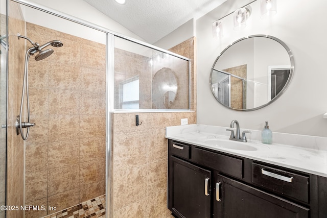 81014 Lockhaven Dr, Yulee, FL 32097 - bathroom featuring a stall shower, vanity, a textured ceiling, and lofted ceiling