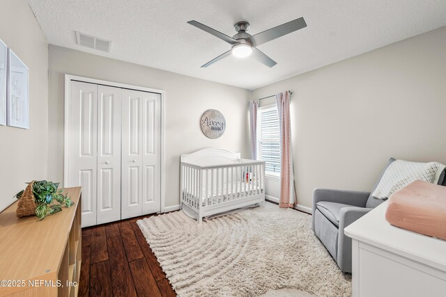 81014 Lockhaven Dr, Yulee, FL 32097 - bedroom with a closet, hardwood / wood-style flooring, baseboards, a ceiling fan, and a crib
