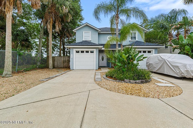 66 W 14th St, Atlantic Beach, FL 32233 - view of front of property with concrete driveway, a garage, stucco siding, and roof with shingles
