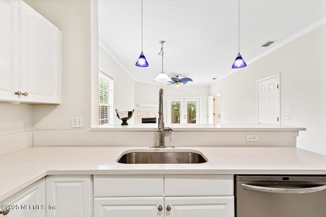 66 W 14th St, Atlantic Beach, FL 32233 - kitchen featuring dishwasher, a sink, ornamental molding, white cabinets, and light countertops