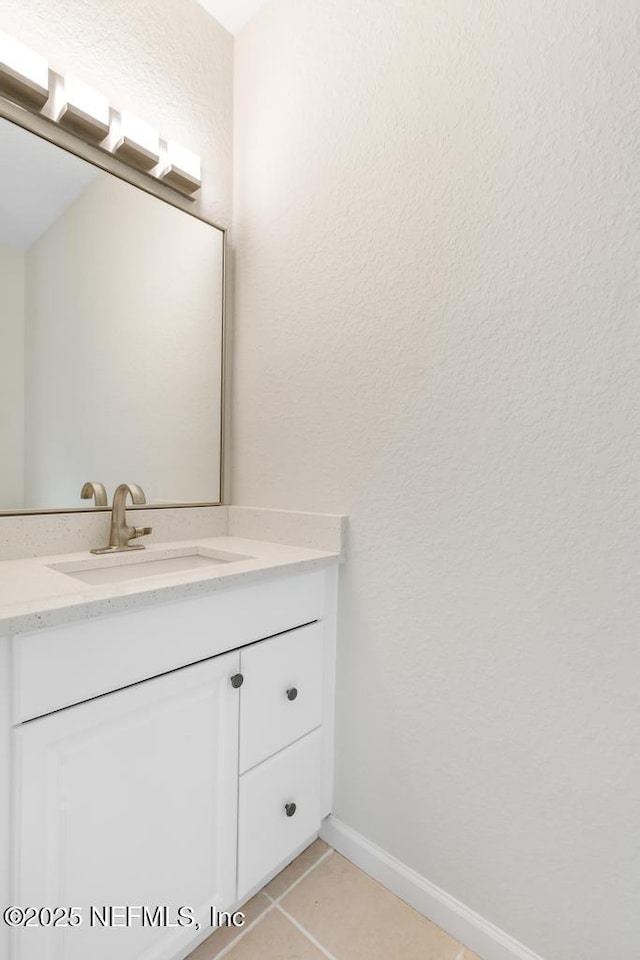 66 W 14th St, Atlantic Beach, FL 32233 - bathroom featuring vanity, tile patterned floors, and baseboards