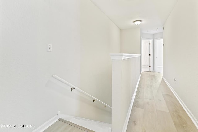 66 W 14th St, Atlantic Beach, FL 32233 - hallway with light wood-style floors, an upstairs landing, and baseboards