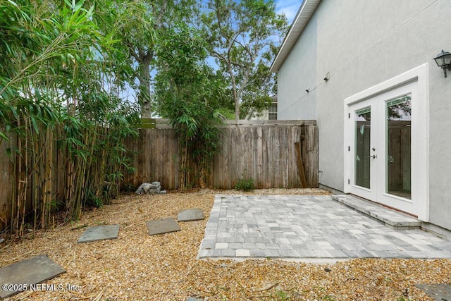 66 W 14th St, Atlantic Beach, FL 32233 - fenced backyard with french doors and a patio area