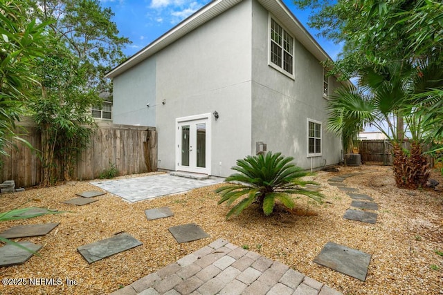 66 W 14th St, Atlantic Beach, FL 32233 - back of house with french doors, stucco siding, a patio, a fenced backyard, and central air condition unit