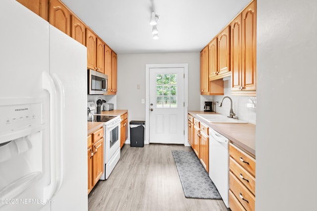 10836 Hawaii Dr S, Jacksonville, FL 32246 - kitchen featuring white appliances, a sink, light wood finished floors, light countertops, and decorative backsplash
