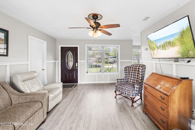 10836 Hawaii Dr S, Jacksonville, FL 32246 - foyer entrance featuring ceiling fan, light wood-style flooring, a decorative wall, and a wainscoted wall