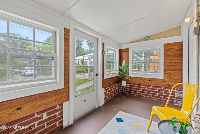 82 Kings Ferry Way, Saint Augustine, FL 32084 - unfurnished sunroom with lofted ceiling, concrete floors, and wooden walls