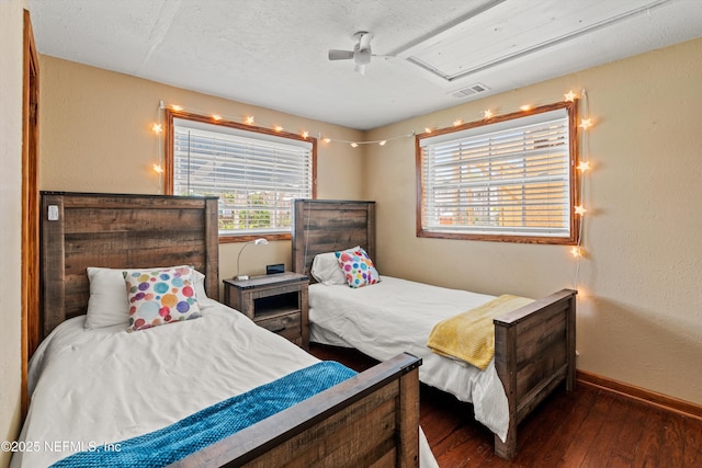 82 Kings Ferry Way, Saint Augustine, FL 32084 - bedroom featuring wood-type flooring, baseboards, attic access, a textured ceiling, and a ceiling fan
