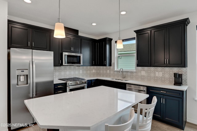 564 Jubilee Cir, Yulee, FL 32097 - kitchen with appliances with stainless steel finishes, tasteful backsplash, a breakfast bar, a kitchen island, and dark cabinets